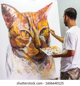 An Asian artist paint portrait ginger cat, acrylic color on white canvas.