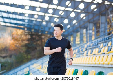 Asian athlete on a morning jog near the stadium, successful male businessman is engaged in fitness in the morning before work