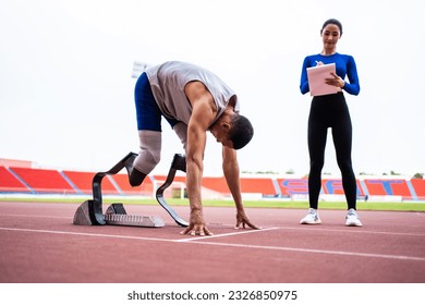 Asian athlete with prosthetic blades and trainer workout in stadium. Attractive amputee male runner and young sportswoman feel happy and enjoy practicing workout for Paralympics running competition. - Powered by Shutterstock