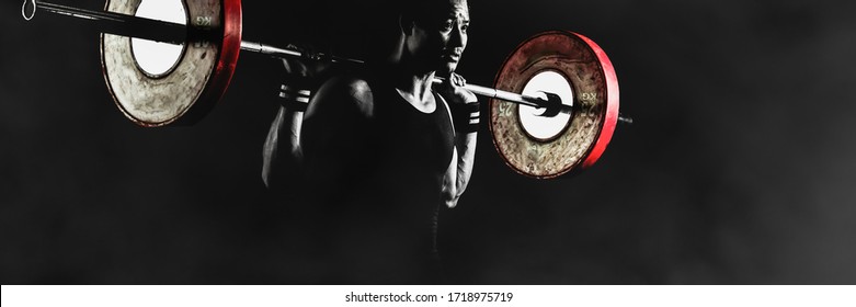 asian athletic strong man having workout and bodybuilding with barbells weight lifting backsquat style in gym and fitness center in dark and two tone - Powered by Shutterstock