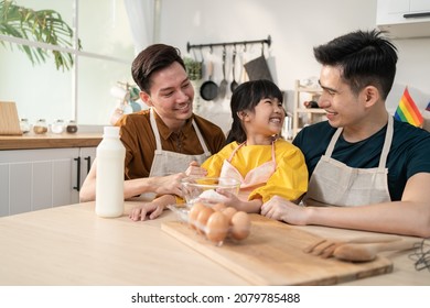 Asian Attractive LGBTQ Gay Family Teach Girl Kid Making Yeast Dough. Handsome Male Couple Take Care And Spend Time With Little Adorable Child Bake Bakery In Kitchen, Enjoy Parenting Activity At Home.