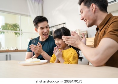 Asian Attractive LGBTQ Gay Family Celebrate Birthday Girl Kid In House. Handsome Male Couple Take Care And Surprise Little Adorable Girl Child With Cake And Present Gift On Her Special Day At Home.