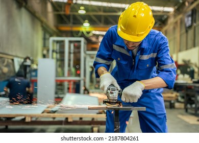 Asian attractive man industrial worker working in manufacturing plant. Young handsome male industry factory engineer wear helmet and processes order and product at manufactory warehouse with happiness - Shutterstock ID 2187804261