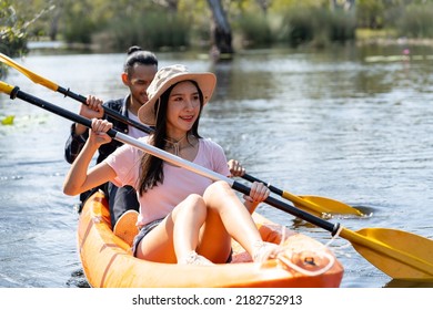 Asian Attractive Romantic Young Couple Rowing Kayak In A Forest Lake. Backpacker Man And Woman Travel And Kayaking On Canoe In Beautiful Mangrove Forest Enjoy Spend Time On Holiday Vacation Together.