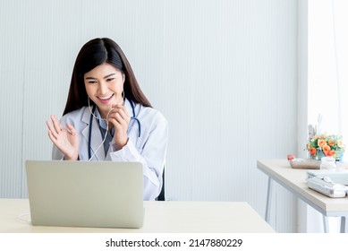 Asian Attractive Woman Doctor Looking At And Using A Computer Notebook To Provide Advice To Patients By Communication Online, To Health Care And Doctor Online Concept.