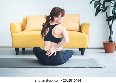 Asian Attractive Young Woman, Is Currently Having A Waist Pain During  Exercise In Home, Due To Osteoarthritis, To Sports And Health Care Concept.