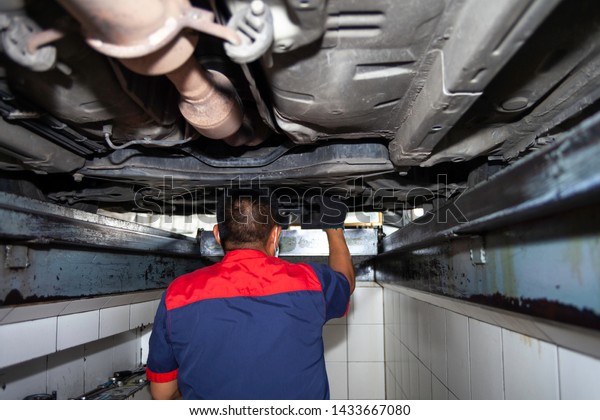 Asian auto\
mechanic  working at auto service\
shop