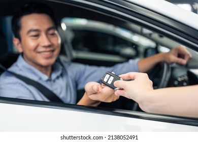 Asian Automotive Mechanic Repairman Handing Car Remote Key To Client. Vehicle Service Manager Give The Key Back To Car Owner After Successful Of Checking And Maintenance Car Engine In Mechanics Garage