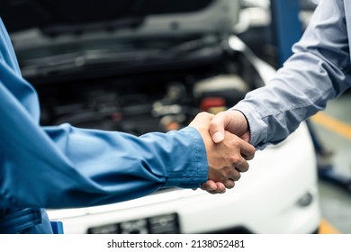 Asian Automotive Mechanic Repairman Handshake With Client In Garage. Vehicle Service Manager Working In Mechanics Workshop, Feel Happy And Success After Check And Maintenance Car Engine For Customer.