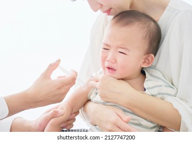 Asian baby being injected at a hospital
