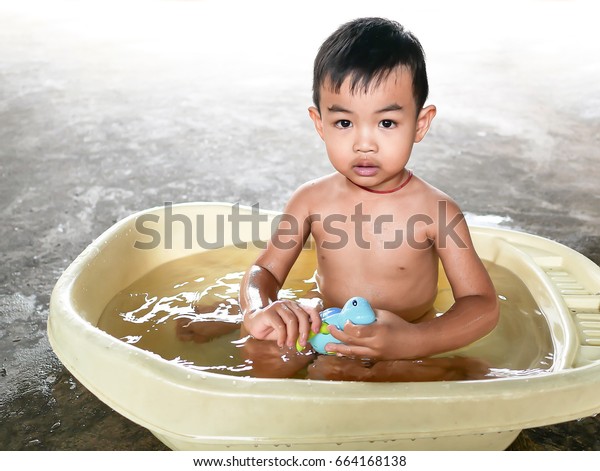 asian\
baby boy bathed in the bath and playing with\
toys