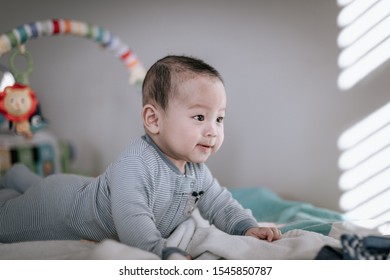 Asian Baby Boy Doing Tummy Time At Home