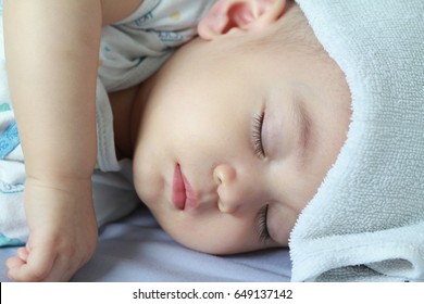 Asian Baby Boy Get Sick,he Has Got Fever,running Nose And Hi Fever,flu,sleeping On Parent Bed. He Has Wet Small Towel On His Forehead.Poor Baby Catch Cold From His Sister Who Went To School.