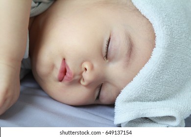 Asian Baby Boy Get Sick,he Has Got Fever,running Nose And Hi Fever,flu,sleeping On Parent Bed. He Has Wet Small Towel On His Forehead.Poor Baby Catch Cold From His Sister Who Went To School.