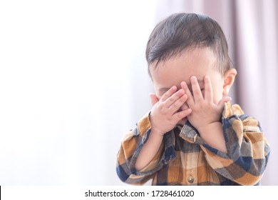 Asian baby boy playing hide and seek hiding face with parents,Concepts of learning development of child by playing. - Powered by Shutterstock