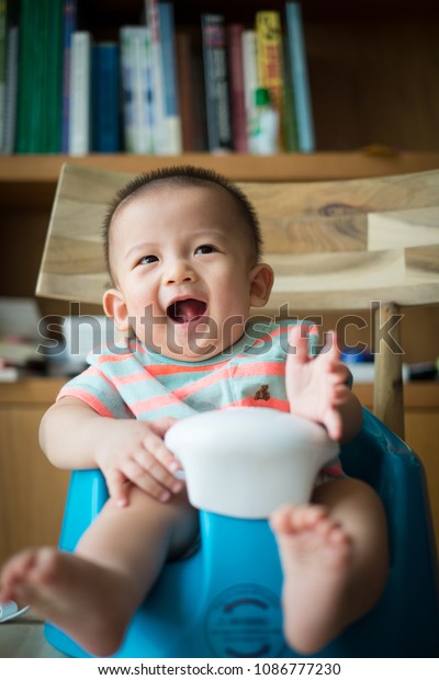 Asian Baby Boy Sitting Front Bookshelf Royalty Free Stock Image