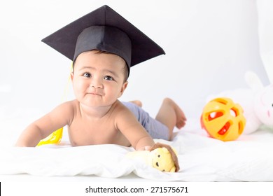 Asian baby boy wearing a graduation black cap