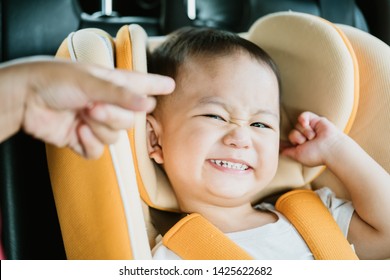 Asian Baby Boy While Mother Scolding On Car Seat In The Car When He Go To School In The Morning.Little Asian Toddler Boy Make Boring Face.