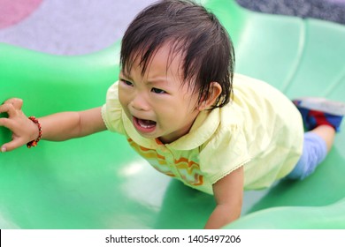 Asian Baby Child Girl Crying And Sad Because She Falling From A Slider Bar Toy At The Playground.