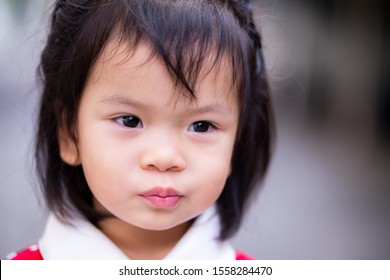Asian baby child girl make a pucker up lips. Adorable kid. Close up. Baby age 2 years 9 months. A girl hair black. - Shutterstock ID 1558284470