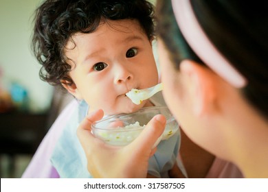 Asian Baby Children Girl With Curly Hair Feeding