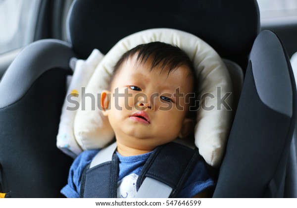Asian baby crying on\
car seat, crying boy