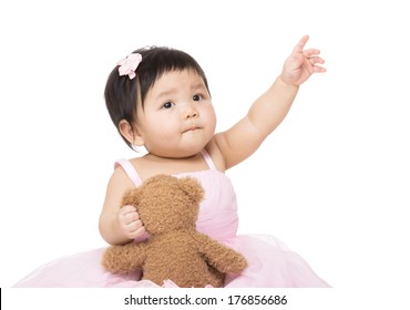 Asian Baby Girl With Doll And Pointing Up