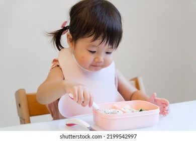 Asian Baby Girl Eating Lunch Box Alone