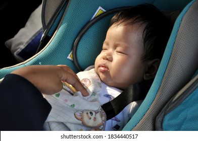 Asian Baby Girl On The Car Seat Is Fast Asleep