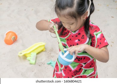 Asian Baby Girl Playing Sand Outdoor. Kid Building Sand Castle. 