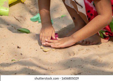 Asian Baby Girl Playing Sand Outdoor. Kid Building Sand Castle. 