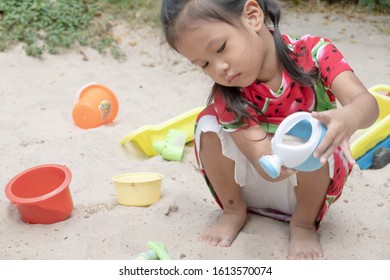 Asian Baby Girl Playing Sand Outdoor. Kid Building Sand Castle. 