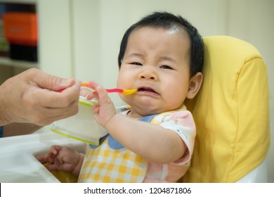 Asian Baby Girl Refusing To Eat Food.tradition Weaning