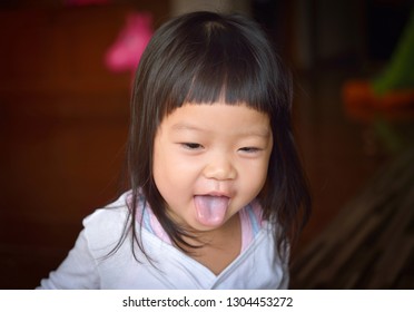 Asian Baby Girl Showing Her Tongue Stock Photo 1304453272 | Shutterstock