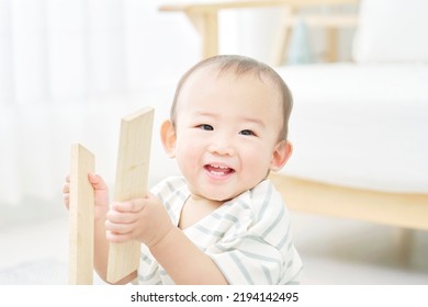 Asian Baby Playing With The Building Blocks At The Living Room