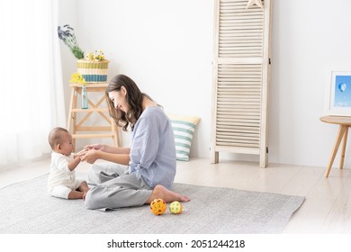 Asian Baby Playing With Mom