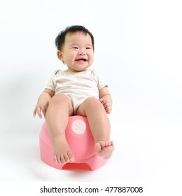 Asian Baby Sitting On Potty Over White Background