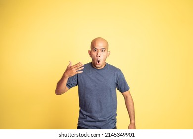 asian bald man opening his mouth with spiciness expression