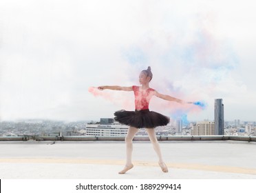 Asian ballerina ballet girl dancing with colour smoke on rooftop and skyscraper city view background. Female ballet dancer practicing dancing. Young ballerina ballet girl dancing - Powered by Shutterstock