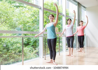 Asian Ballet Dancer Exercising In Studio