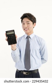 Asian Bank Teller With A Calculator 