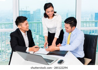 Asian Banker Counseling Client Finance Investment In Bank Office 