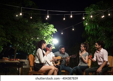 Asian Barbecue Party Men Are Singing Their Friends. At Night