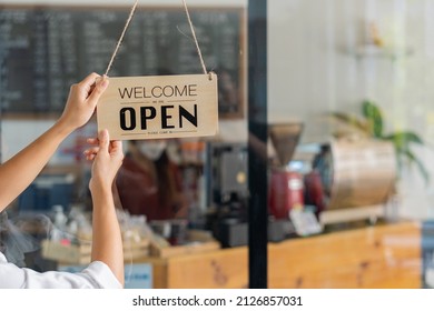 Asian Barista Female Hand Holding Open Sign In Coffee Shop Welcome To The Bar Counter In The Cafe. Business Owner Startup Ideas