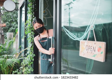 Asian Barista Woman Worker New Normal Wearing Facemask Protection COVID-19 Coronavirus Pandemic Opening Shop For Customer Service Serving Food At Café Restaurant Store Small Startup Business Owner