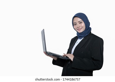 Asian Beautiful Business Woman Wearing Hijab Smiling While Holding A Laptop