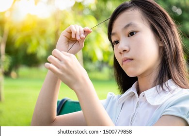 Asian Beautiful Child Girl Pulling Her Hair With Her Fingers In Mental Health Problems,nervous System,brain System,schizophrenia,female Psychiatric Patient In Trichotillomania Hair-pulling Disorder 