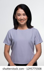 Asian Beautiful Elderly Aging Society 50s 60s Years Old Woman Wear Gray Casual Clothes Short Black Hair With Make Up, Studio Lighting White Background Copy Space With Smile Face Eyes Head Shot