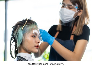 Asian Beautiful Girl Changing New Hair Style And Color In Beauty Salon. Professional Hairdresser Barber Wear Face Mask To Prevent From Covid19 Pandemic Dye Woman Customer Hair For Hairdo In Barbershop