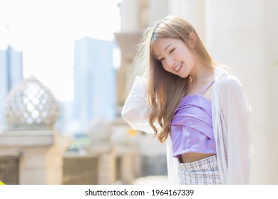 Asian Beautiful Lady Who Has Bronze Hair Smiles And Walks On The Street In Fashion Style Theme.